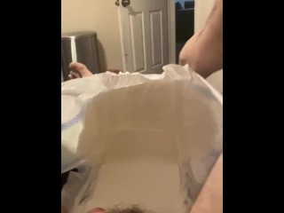 Diaper boy inserting butt plug